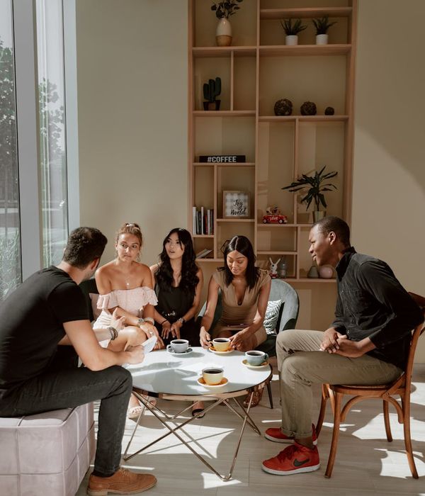 A diverse group of people smiling and talking in a friendly gathering.